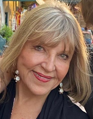 A person smiling at the camera    Description automatically generated